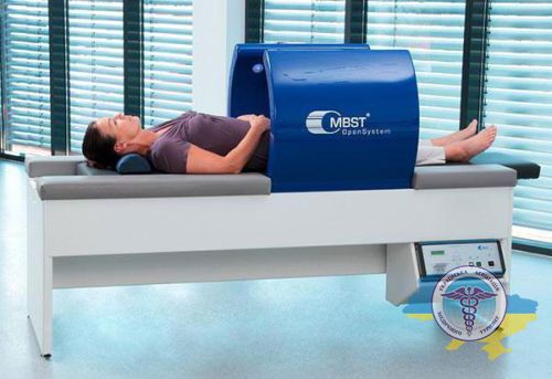 A woman lies down on an MBST machine